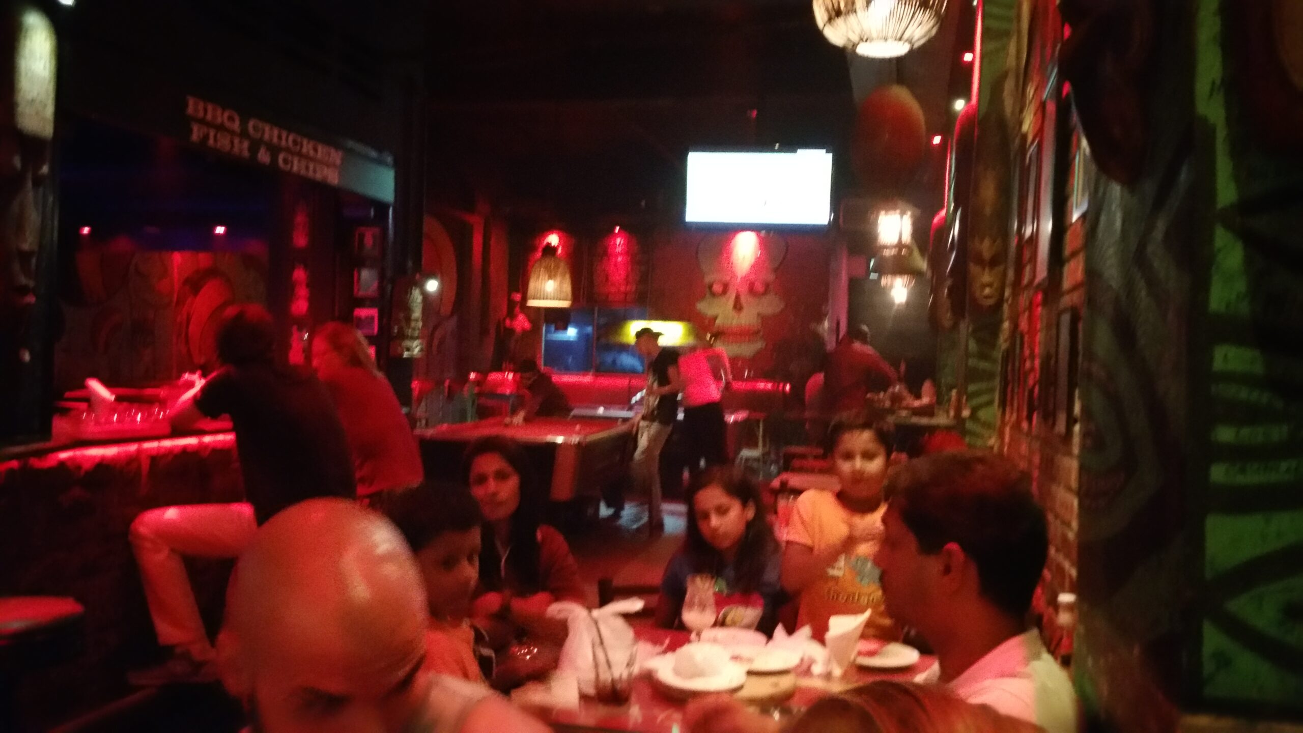Interior d'un local nocturn amb il·luminació vermella i clients asseguts a Kuala Lumpur