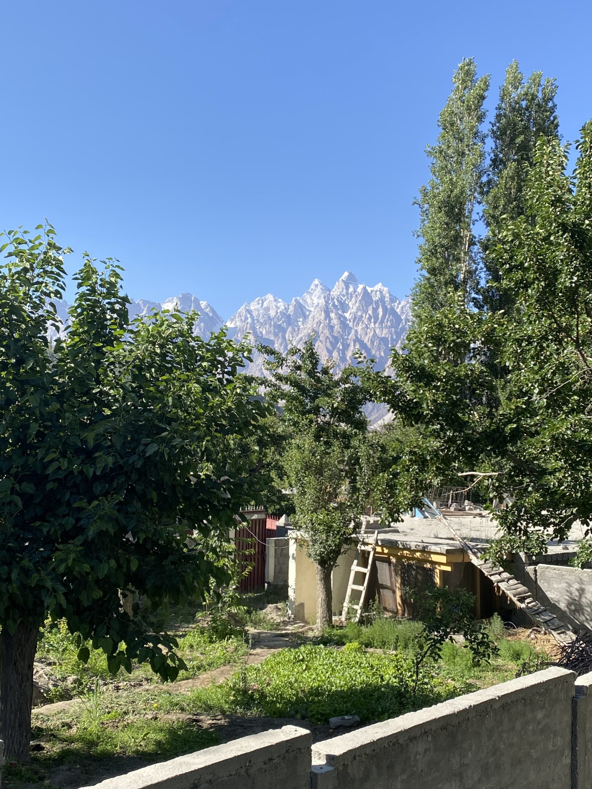El poble de Gulmit envoltat de camps verds i cims nevats del Karakoram