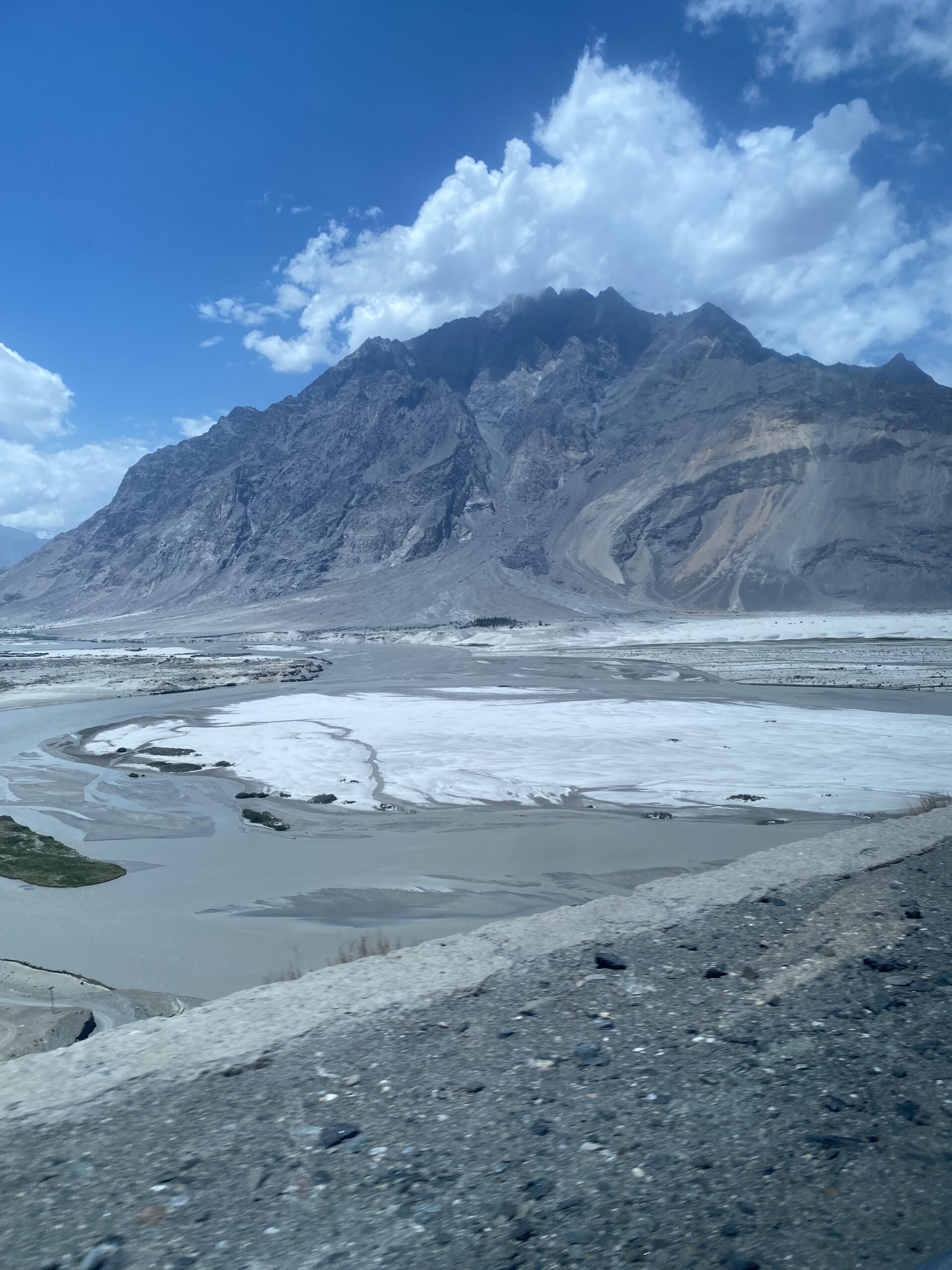 El riu glaciar de Shigar amb el llit de pedres blanques i les muntanyes del Baltistan