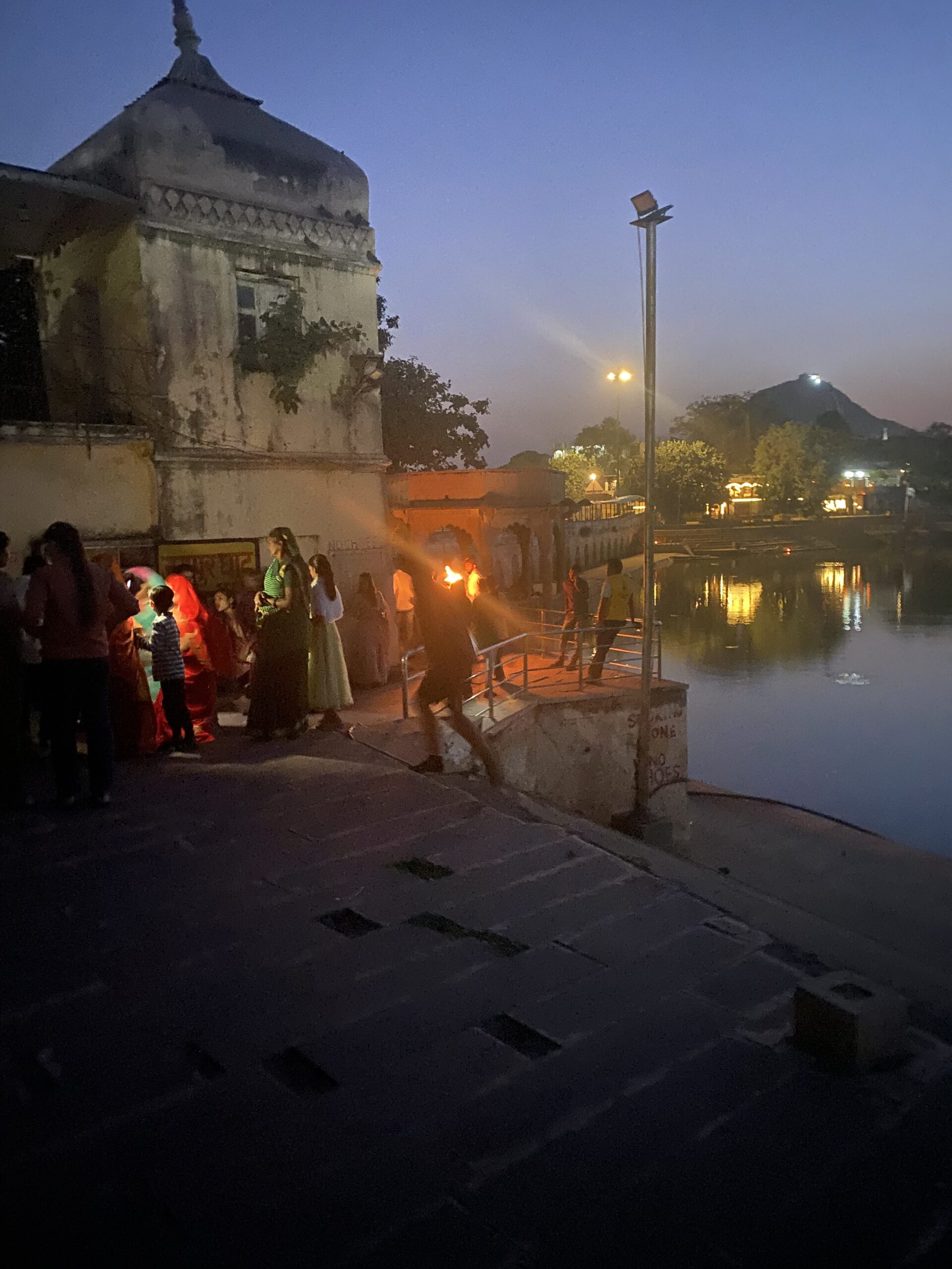 Llums i pelegrins durant una cerimònia religiosa al capvespre als ghats de Pushkar.