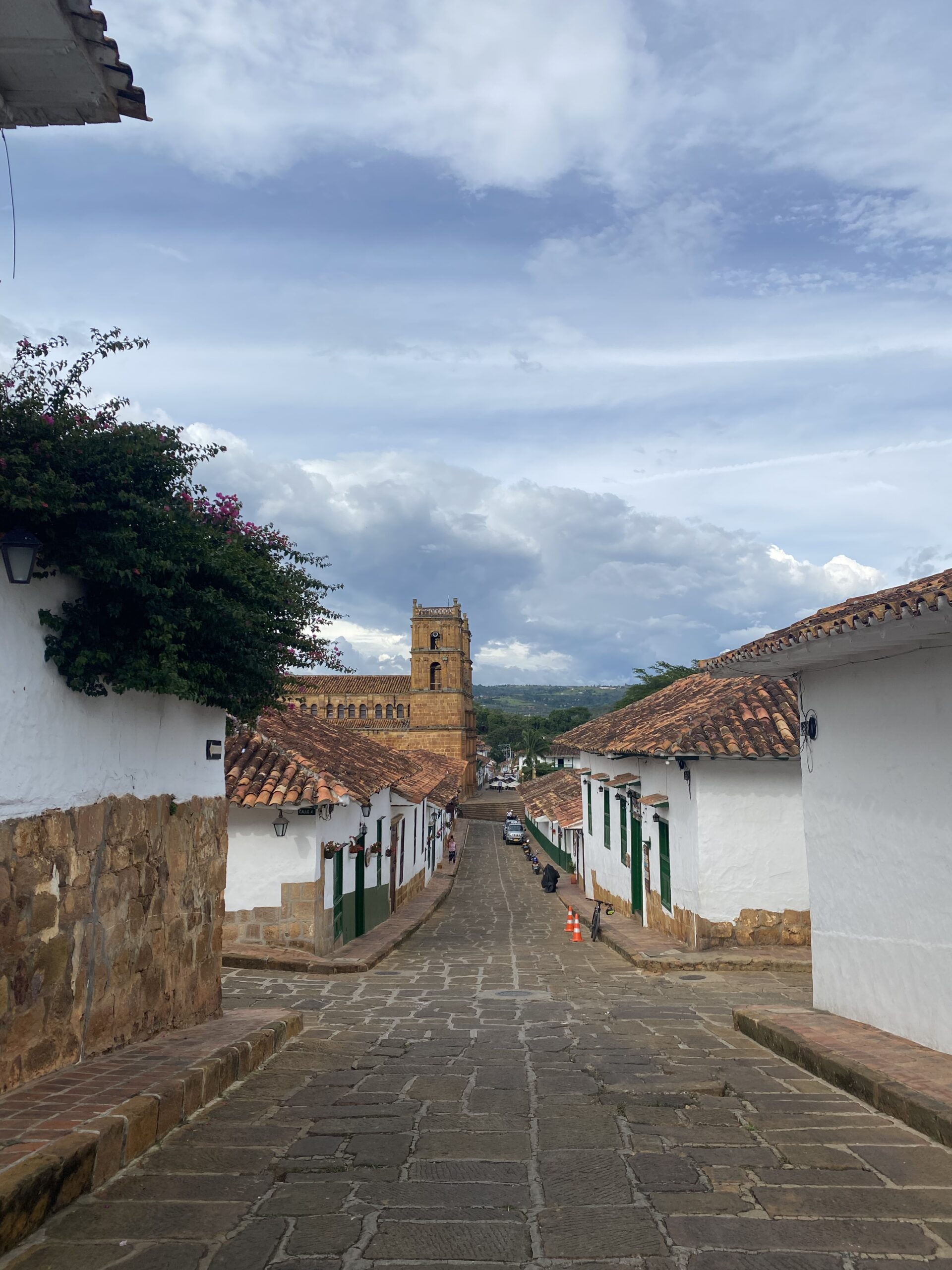 Carrer de Barichara amb cases colonials blanques i una torre al fons