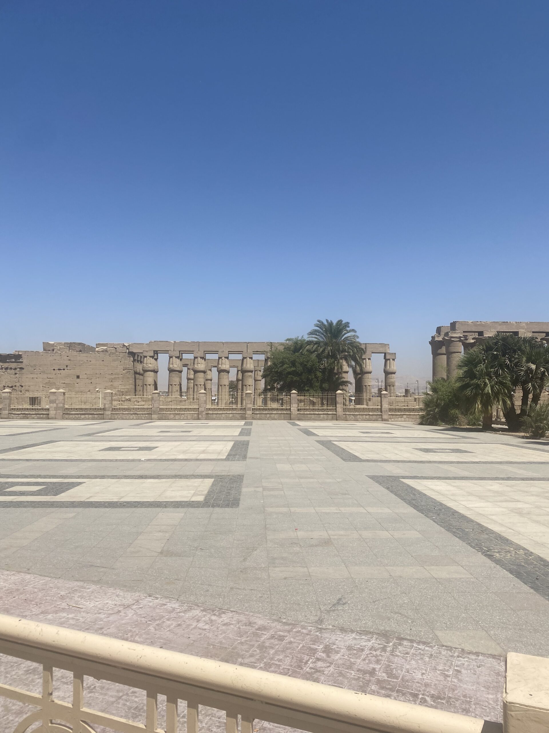 Pati enllosat d'un temple de Luxor amb columnes al fons